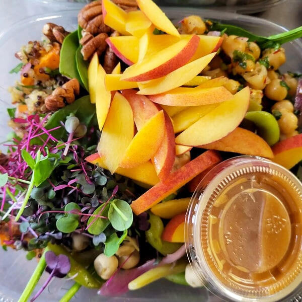 Chef-made bowl with microgreens, fresh fruit and grains.